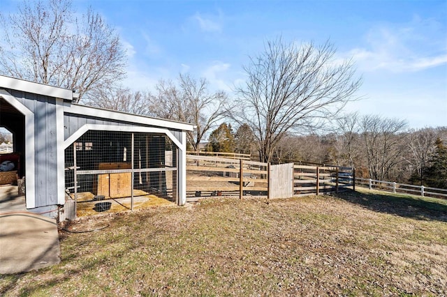 view of yard with an outdoor structure and fence