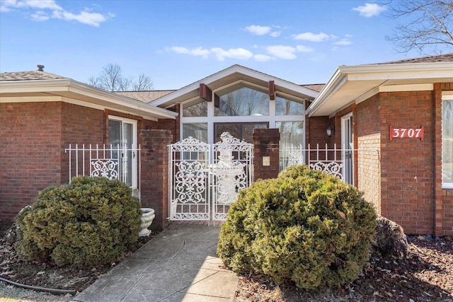 doorway to property with brick siding