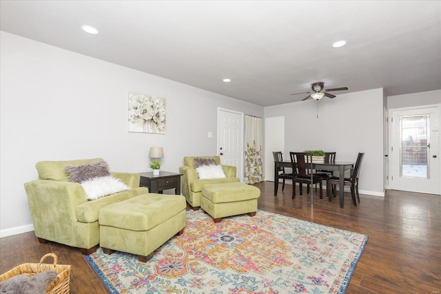 living room with ceiling fan and dark hardwood / wood-style floors