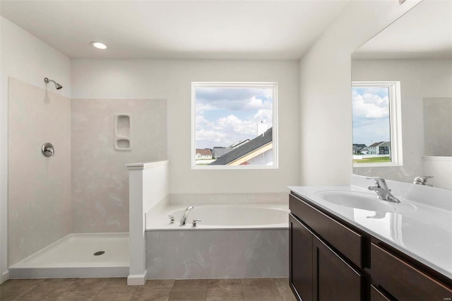 bathroom featuring vanity and shower with separate bathtub