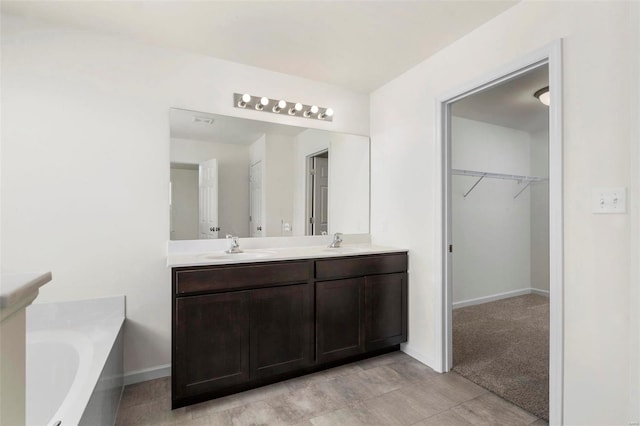 bathroom with vanity and a bath