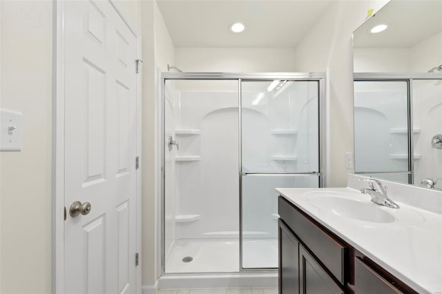 bathroom featuring vanity, tile patterned floors, and a shower with door