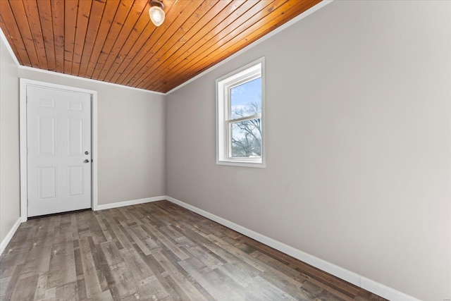 empty room featuring ornamental molding, light wood-type flooring, and wooden ceiling