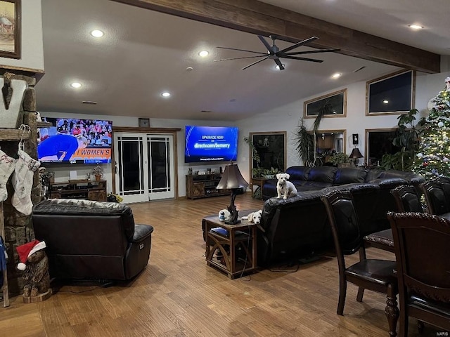 living room featuring ceiling fan, lofted ceiling with beams, and hardwood / wood-style flooring