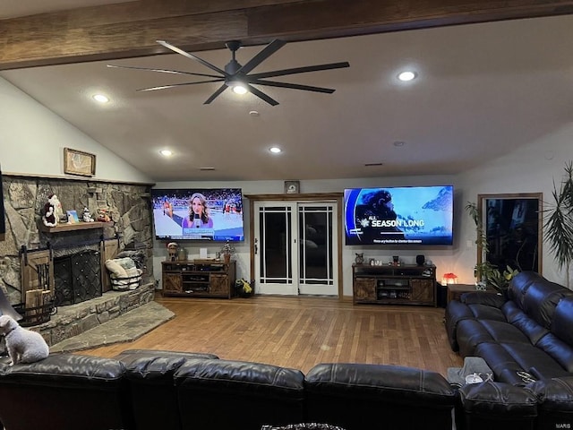 living room with a fireplace, vaulted ceiling with beams, hardwood / wood-style flooring, and ceiling fan