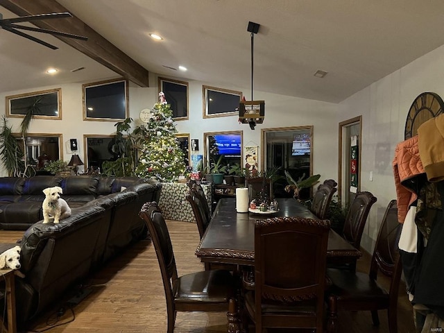 dining area featuring vaulted ceiling with beams, light hardwood / wood-style floors, and ceiling fan