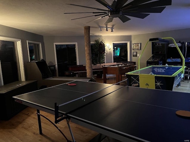 playroom featuring wood-type flooring, rail lighting, and ceiling fan