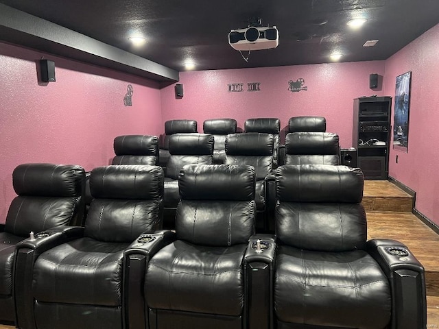 home theater room featuring hardwood / wood-style flooring