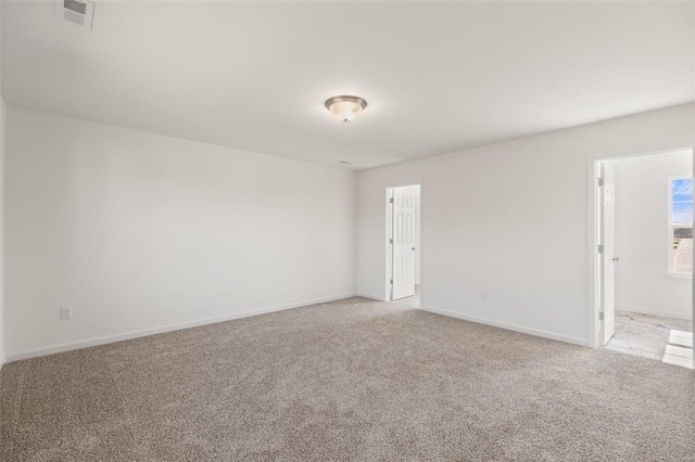 unfurnished room featuring light colored carpet