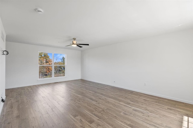 unfurnished room featuring light hardwood / wood-style floors and ceiling fan