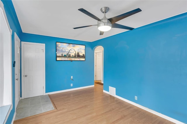 unfurnished room with ceiling fan and light wood-type flooring