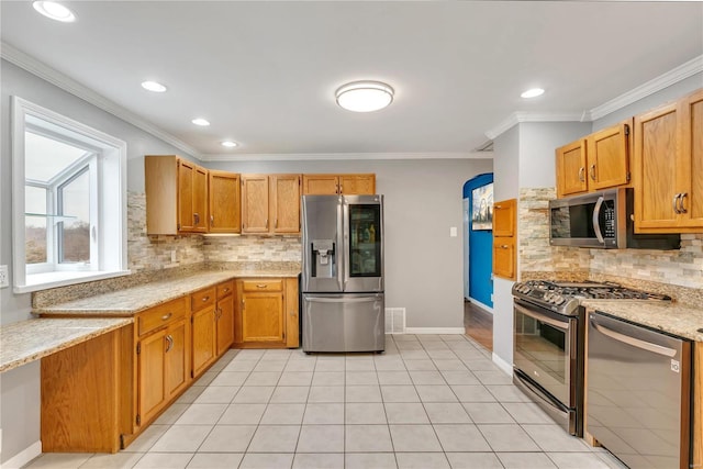 kitchen featuring appliances with stainless steel finishes, backsplash, ornamental molding, and light tile patterned flooring