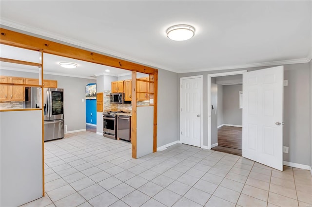 kitchen with stainless steel appliances, backsplash, light brown cabinetry, light tile patterned flooring, and ornamental molding