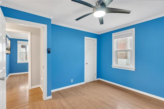 unfurnished bedroom featuring ceiling fan, light hardwood / wood-style flooring, and crown molding