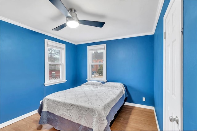 bedroom with ceiling fan, wood-type flooring, and ornamental molding