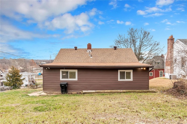 back of house featuring a yard