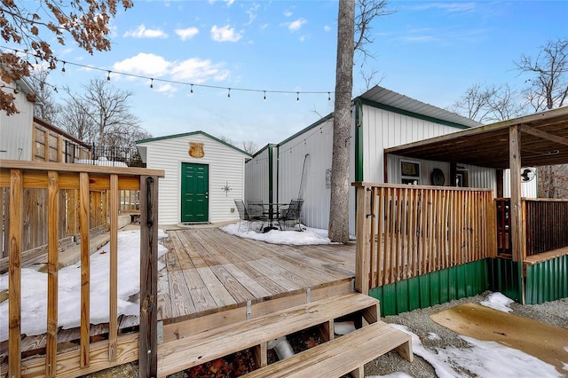 snow covered deck with an outbuilding