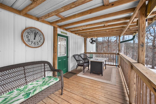 wooden terrace featuring an outdoor fire pit