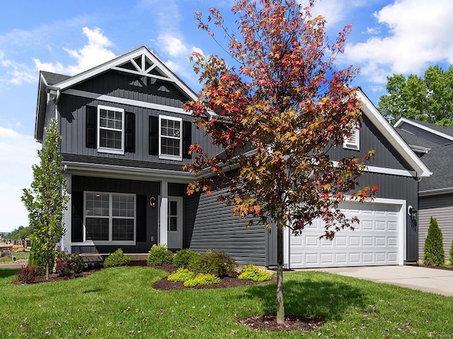 craftsman inspired home featuring a garage and a front lawn