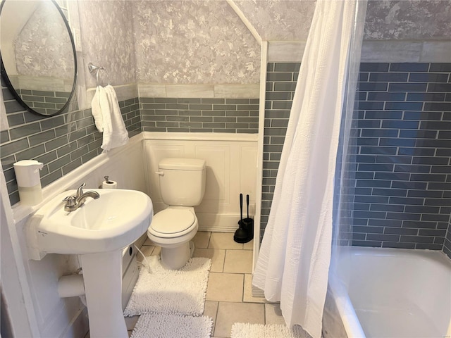 bathroom with tile patterned floors, toilet, and shower / bathtub combination with curtain