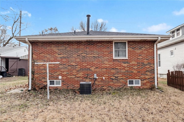 back of property featuring a storage unit and central air condition unit