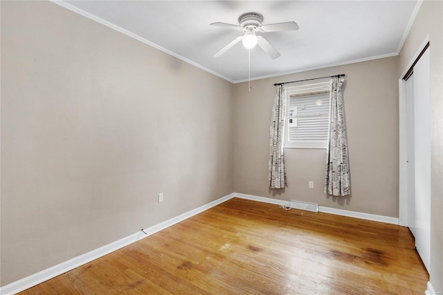 unfurnished room with hardwood / wood-style flooring, ceiling fan, and ornamental molding