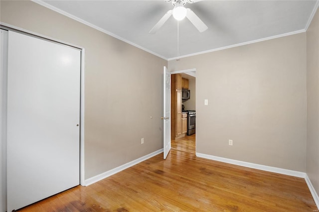 unfurnished bedroom featuring ceiling fan, light hardwood / wood-style floors, and ornamental molding