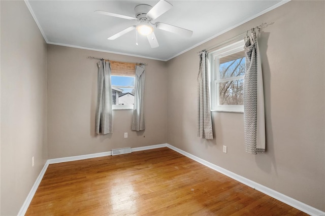 unfurnished room with ceiling fan, wood-type flooring, and ornamental molding