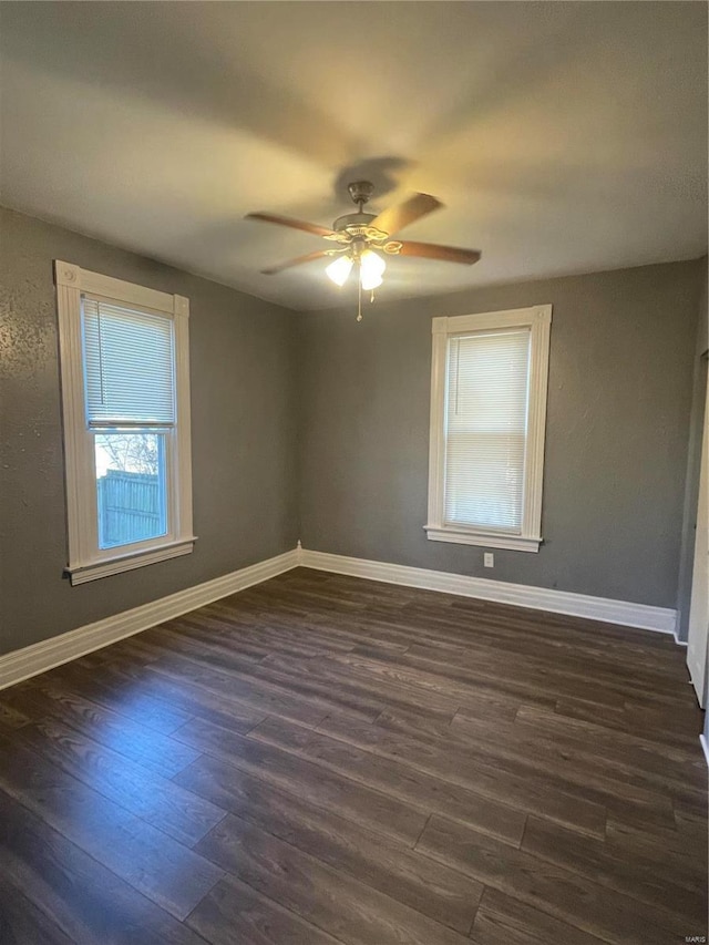 spare room featuring ceiling fan and dark wood-type flooring