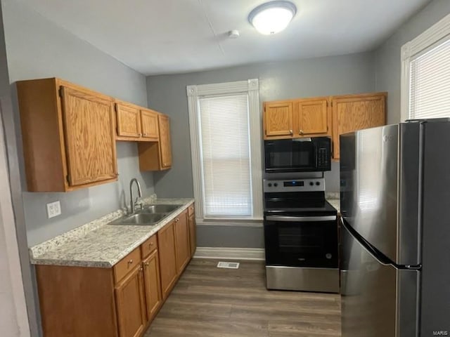 kitchen with sink, dark wood-type flooring, and appliances with stainless steel finishes