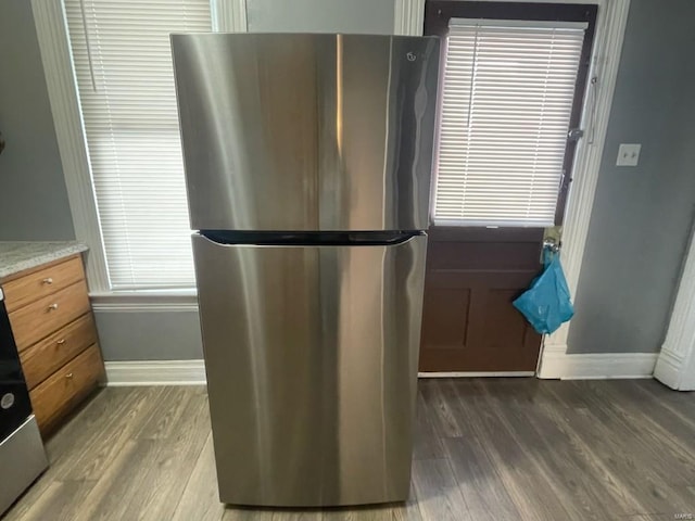 kitchen with stainless steel refrigerator and dark hardwood / wood-style flooring