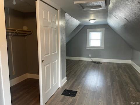 bonus room featuring dark hardwood / wood-style floors and vaulted ceiling