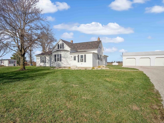 view of home's exterior with a garage, an outdoor structure, and a lawn