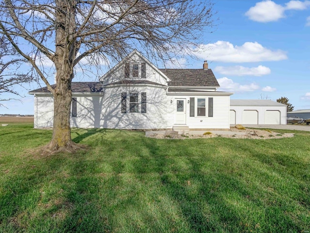 exterior space with a yard, an outdoor structure, and a garage