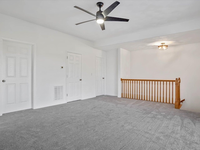 empty room featuring ceiling fan and carpet floors