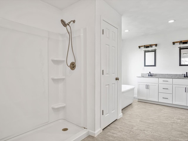 bathroom with vanity and plus walk in shower