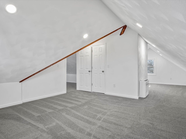 bonus room featuring carpet and vaulted ceiling