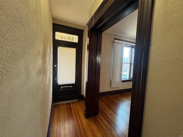 hall with dark hardwood / wood-style flooring