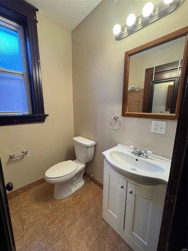 bathroom featuring tile patterned floors, vanity, and toilet