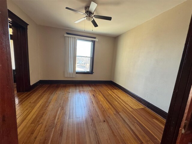 unfurnished room with hardwood / wood-style floors and ceiling fan