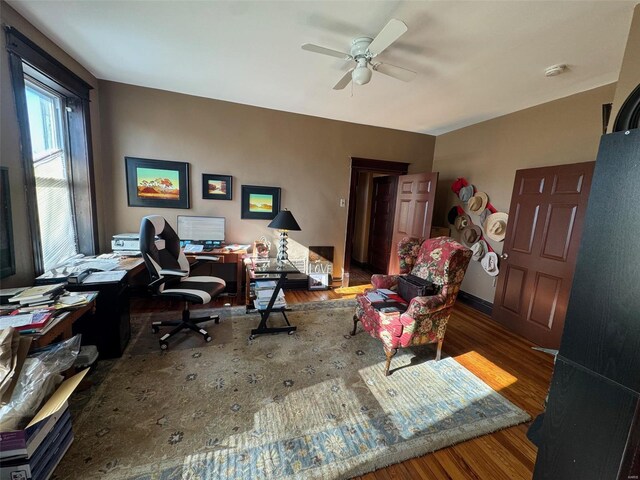 office area with ceiling fan and dark wood-type flooring