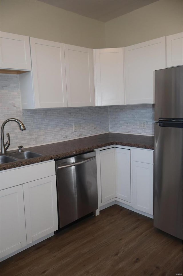 kitchen featuring sink, white cabinets, tasteful backsplash, and stainless steel appliances