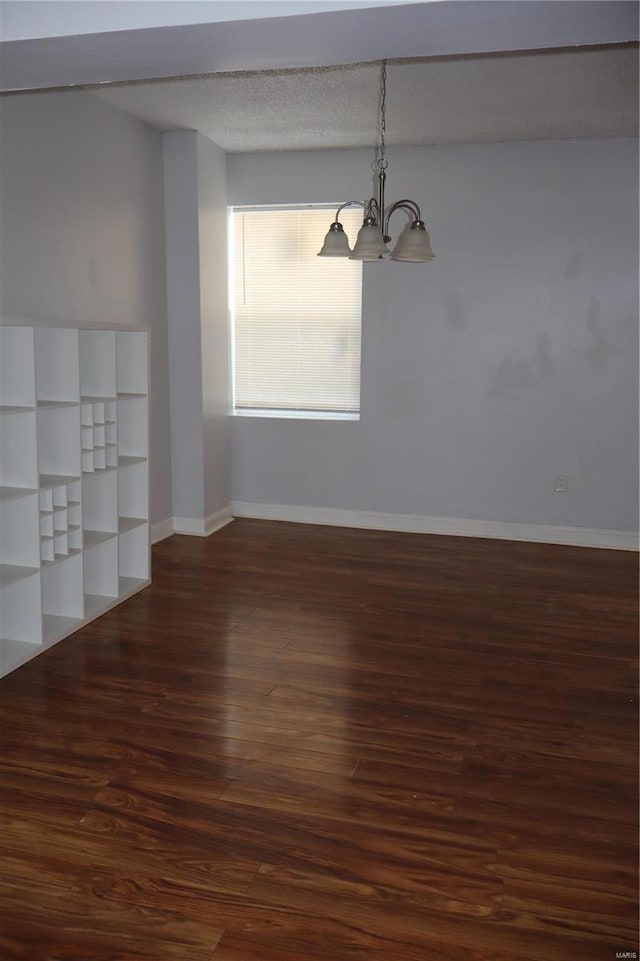 interior space featuring dark wood-type flooring and a chandelier