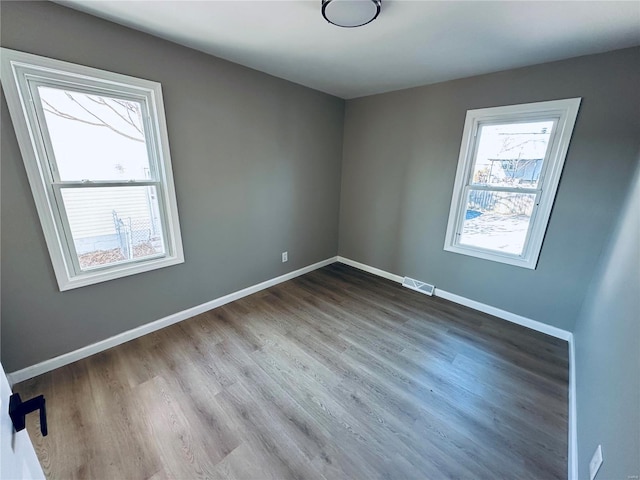 spare room with hardwood / wood-style flooring