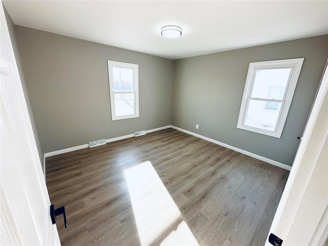 spare room with dark hardwood / wood-style flooring