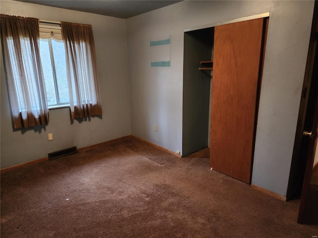 unfurnished bedroom featuring carpet floors and a closet