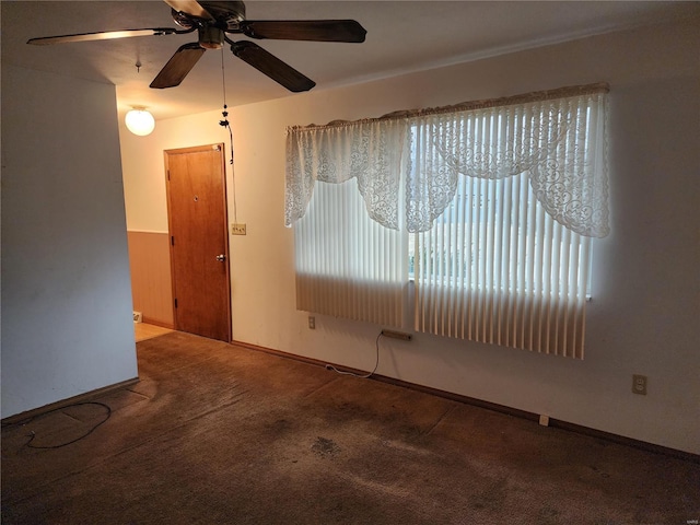 carpeted empty room featuring ceiling fan