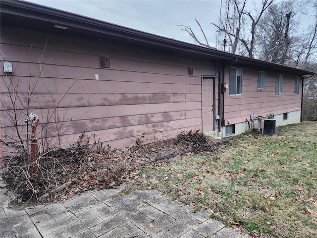 view of side of property with central air condition unit