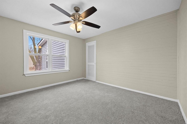 carpeted empty room with ceiling fan