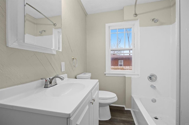 full bathroom with hardwood / wood-style flooring, vanity, toilet, and bathing tub / shower combination